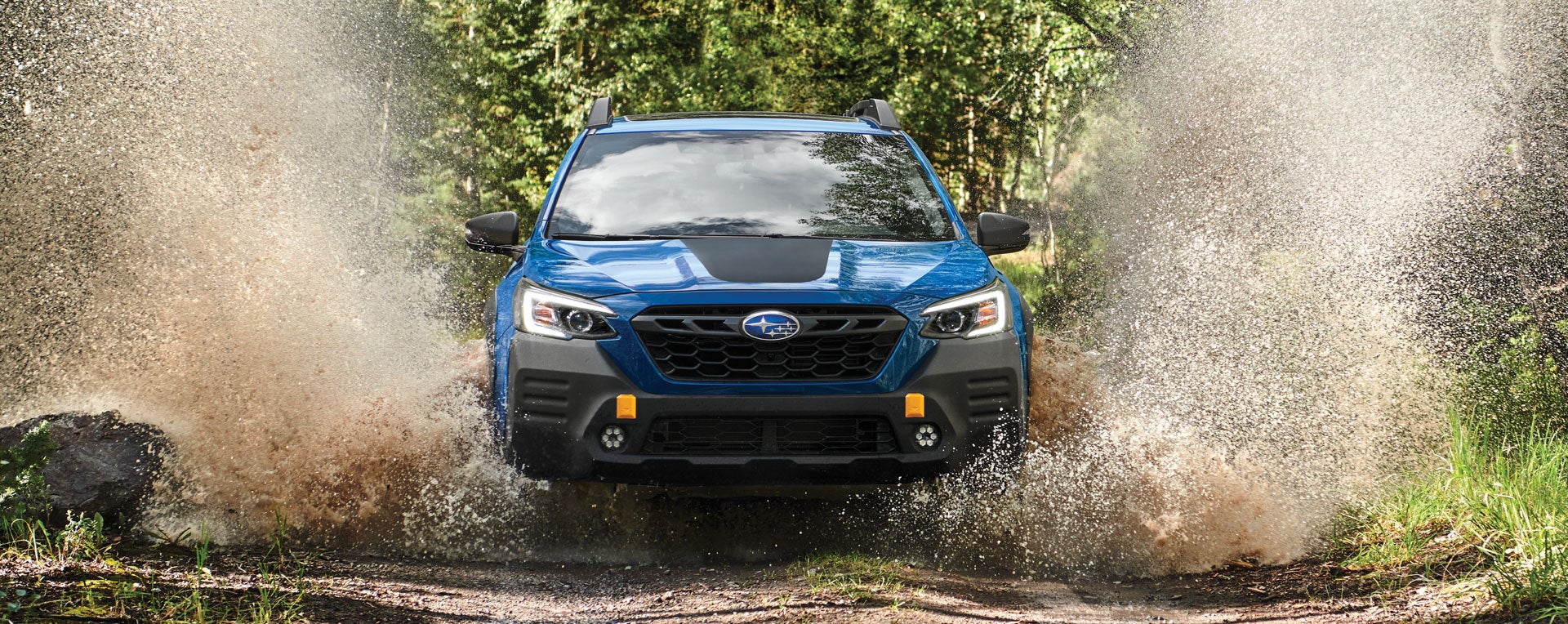 A 2023 Outback Wilderness driving on a muddy trail. | Paul Moak Subaru in Jackson MS