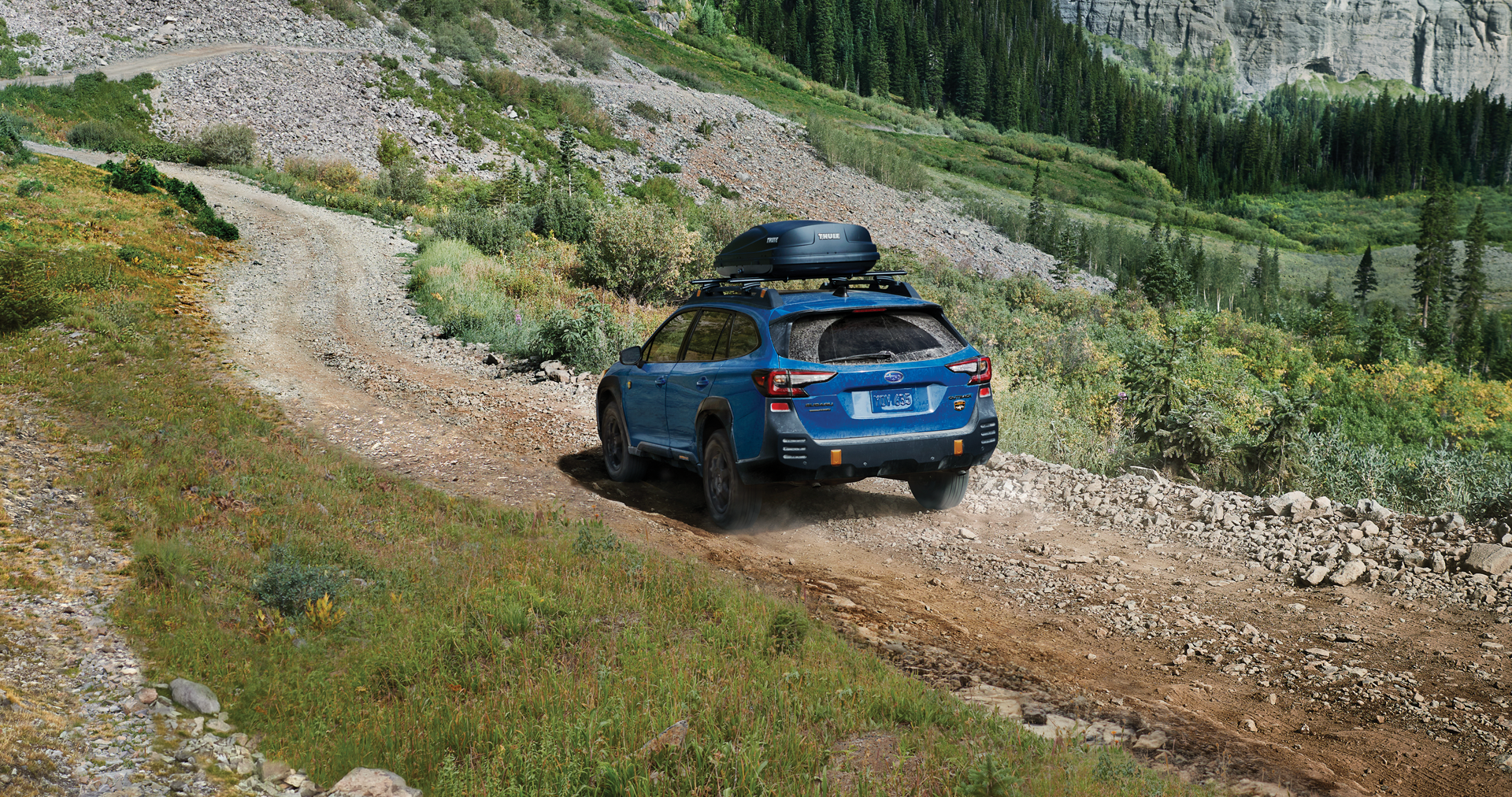 A 2023 Outback Wilderness driving on a trail in the mountains. | Paul Moak Subaru in Jackson MS